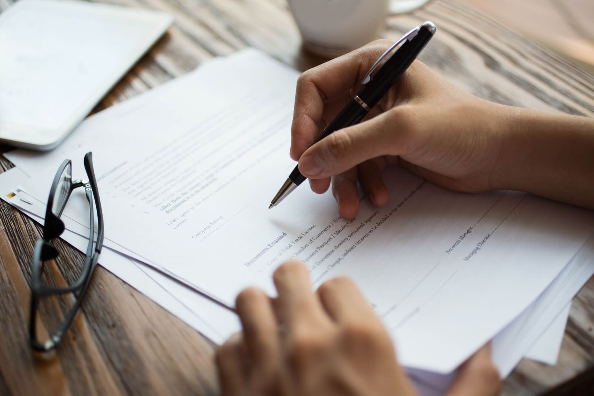 businessman-examining-papers-table (1)